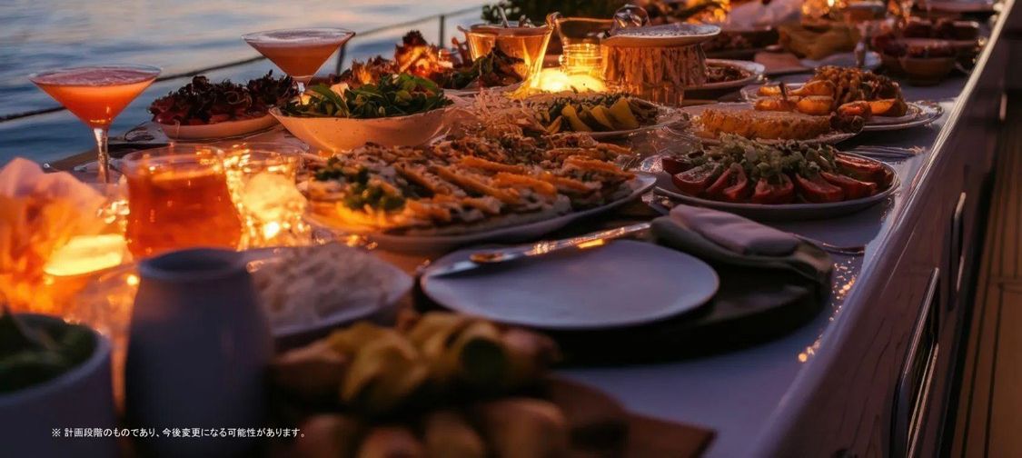 A candlelit dinner spread laid out along the deck of the yacht at sunset