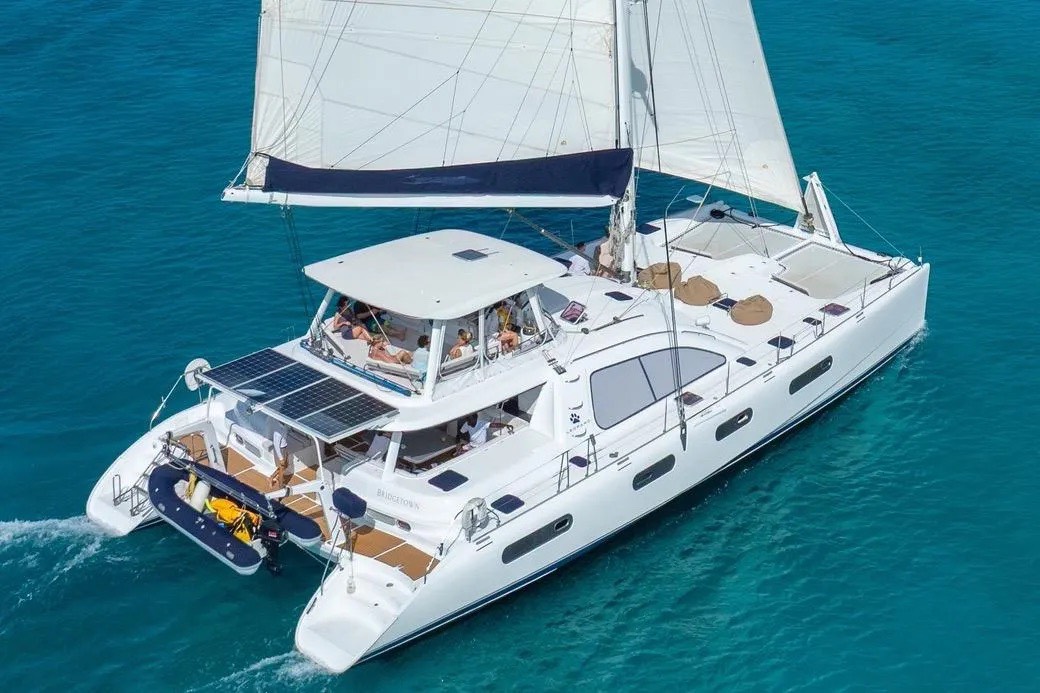 Aerial view of the yacht with guests relaxing on the sun deck