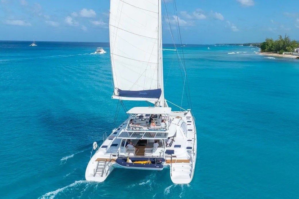 The yacht seen from astern on brilliant turquoise water